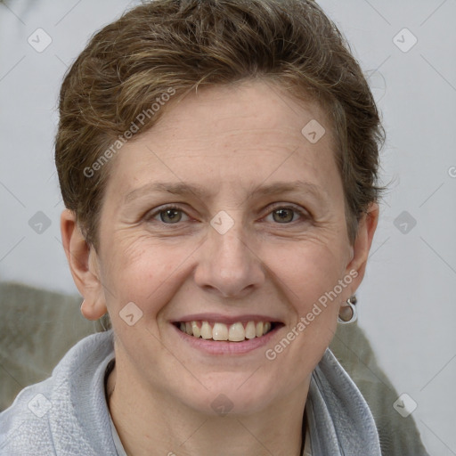 Joyful white adult female with short  brown hair and grey eyes