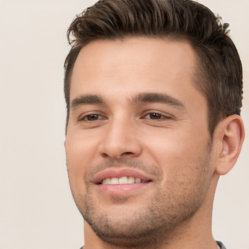 Joyful white young-adult male with short  brown hair and brown eyes