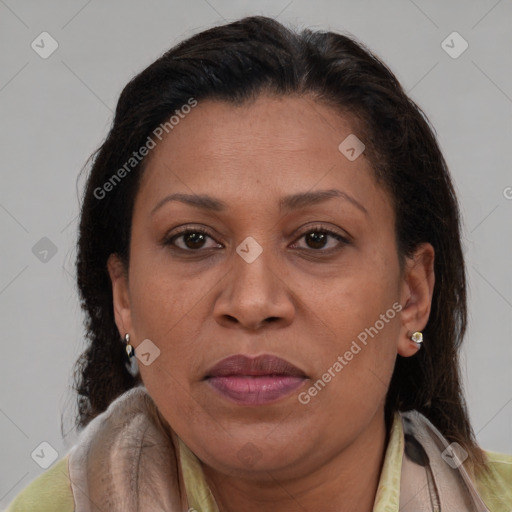 Joyful latino adult female with medium  brown hair and brown eyes