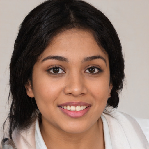 Joyful latino young-adult female with medium  brown hair and brown eyes