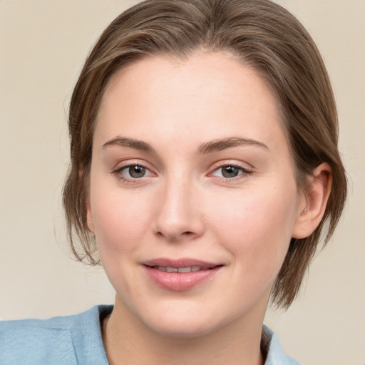 Joyful white young-adult female with medium  brown hair and blue eyes