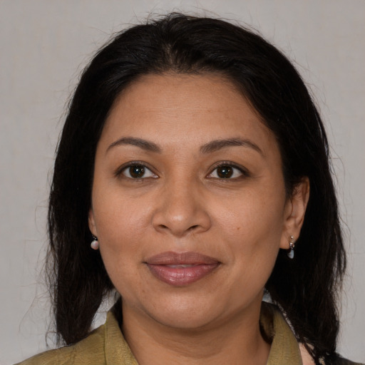 Joyful latino adult female with medium  brown hair and brown eyes