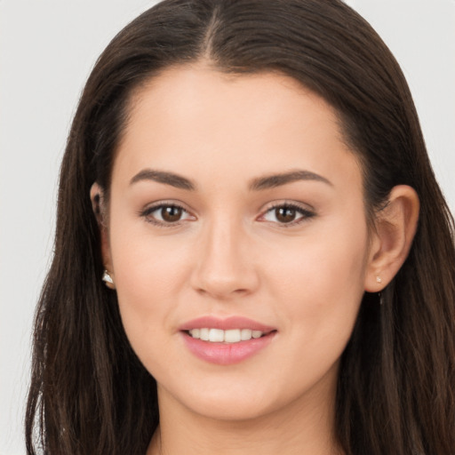 Joyful white young-adult female with long  brown hair and brown eyes