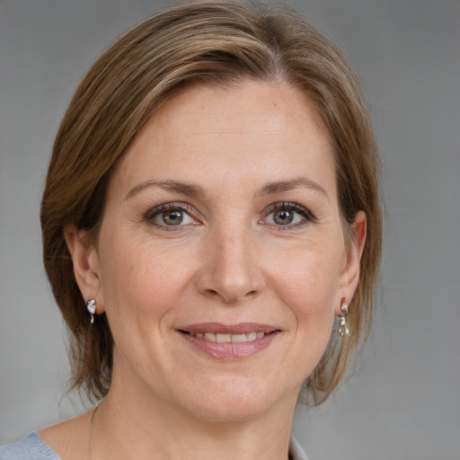 Joyful white adult female with medium  brown hair and grey eyes