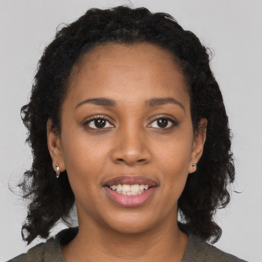 Joyful black young-adult female with medium  black hair and brown eyes