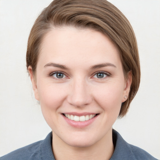 Joyful white young-adult female with medium  brown hair and grey eyes