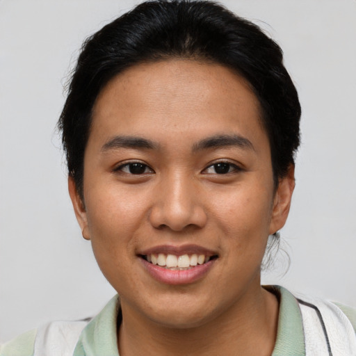 Joyful asian young-adult female with short  brown hair and brown eyes