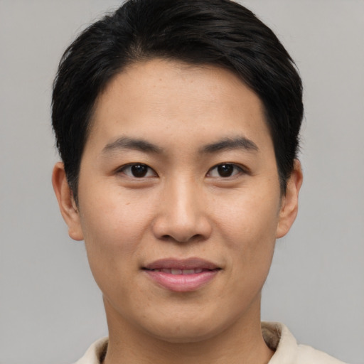 Joyful asian young-adult male with short  black hair and brown eyes