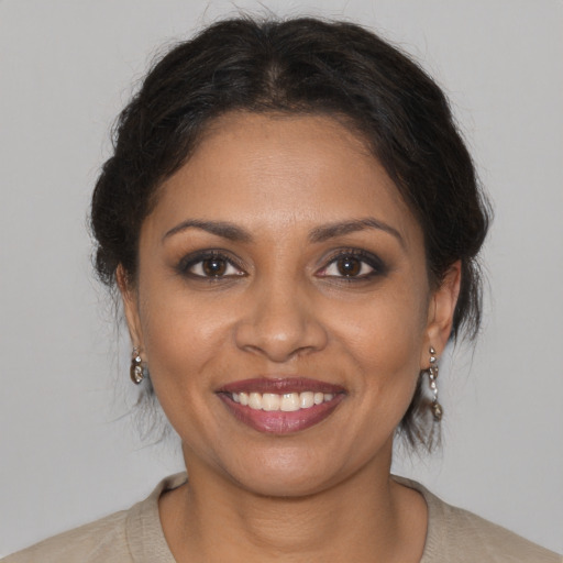 Joyful black young-adult female with medium  brown hair and brown eyes