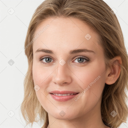 Joyful white young-adult female with medium  brown hair and blue eyes