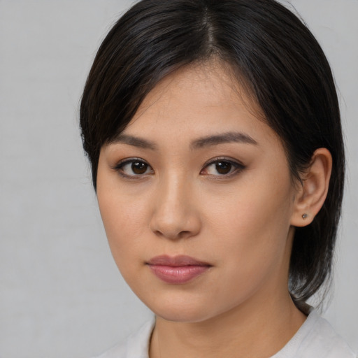 Joyful asian young-adult female with medium  black hair and brown eyes