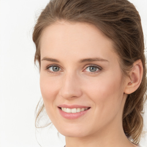 Joyful white young-adult female with medium  brown hair and grey eyes