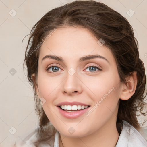 Joyful white young-adult female with medium  brown hair and blue eyes