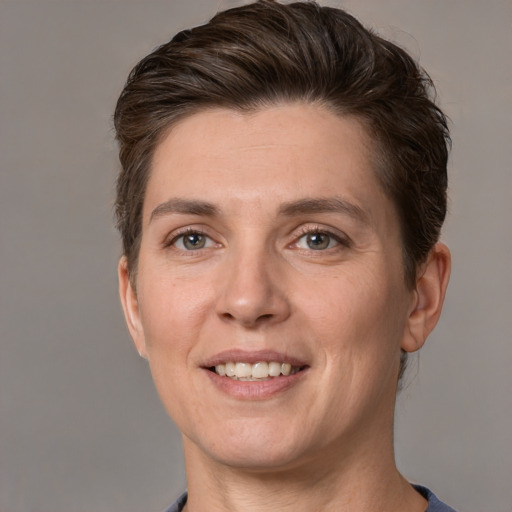 Joyful white adult female with short  brown hair and grey eyes