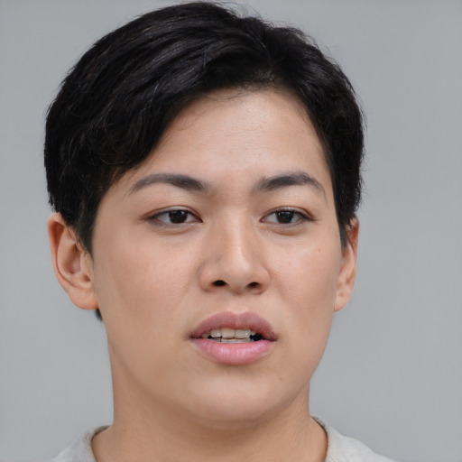 Joyful asian young-adult female with short  brown hair and brown eyes