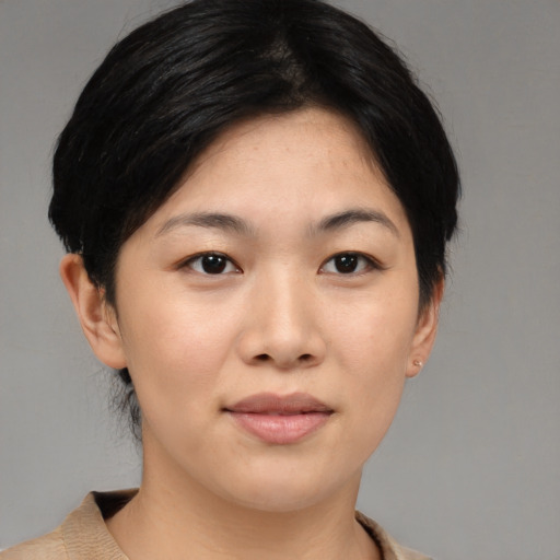 Joyful asian young-adult female with medium  black hair and brown eyes