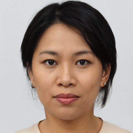 Joyful asian young-adult female with medium  black hair and brown eyes