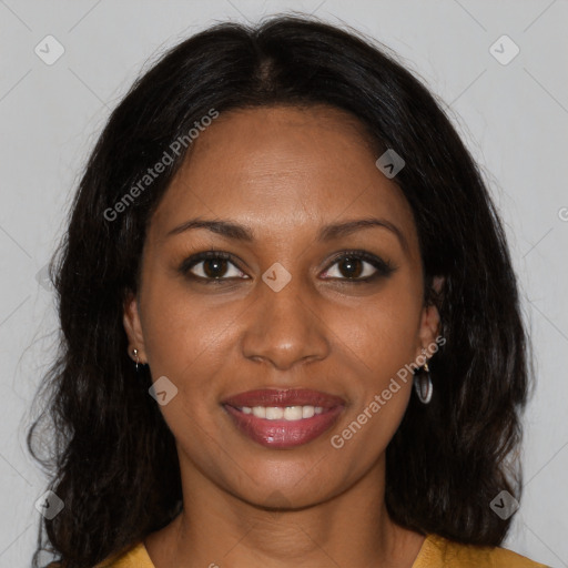 Joyful black young-adult female with long  brown hair and brown eyes