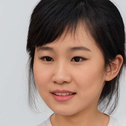 Joyful asian young-adult female with medium  brown hair and brown eyes