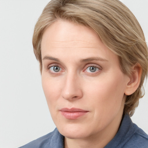 Joyful white young-adult female with medium  brown hair and blue eyes