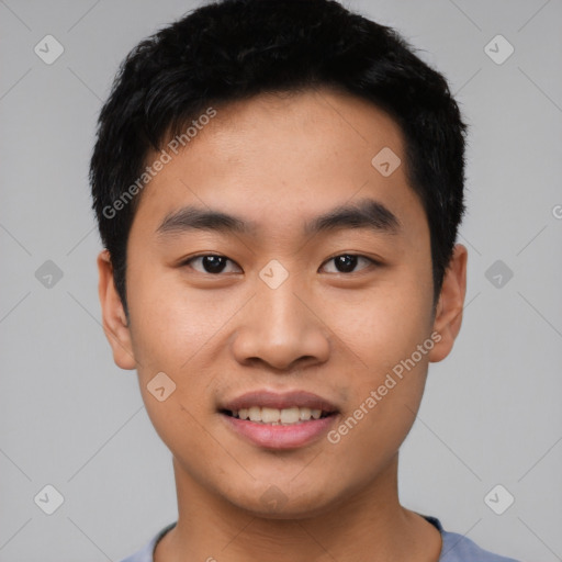 Joyful asian young-adult male with short  black hair and brown eyes