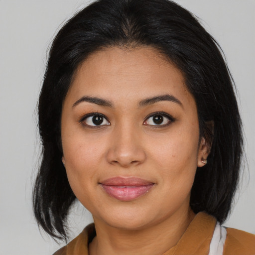 Joyful asian young-adult female with medium  brown hair and brown eyes