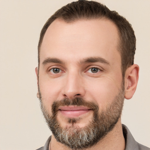 Joyful white adult male with short  brown hair and brown eyes