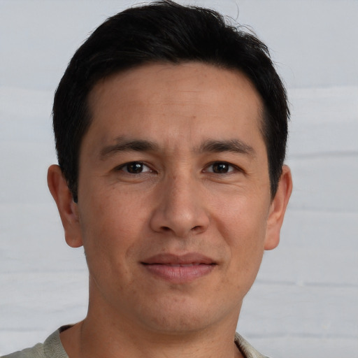 Joyful asian adult male with short  brown hair and brown eyes