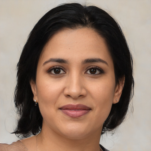Joyful latino young-adult female with medium  black hair and brown eyes