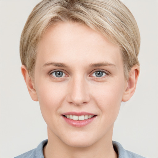 Joyful white young-adult female with short  brown hair and grey eyes