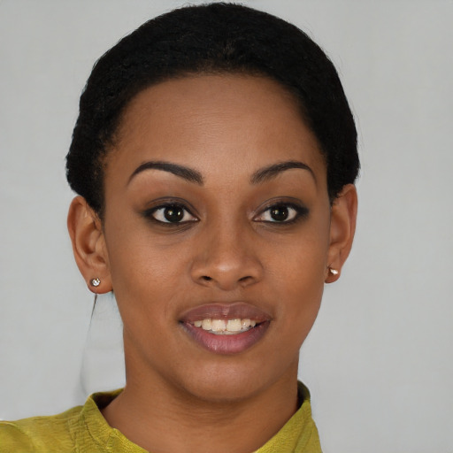 Joyful black young-adult female with short  black hair and brown eyes