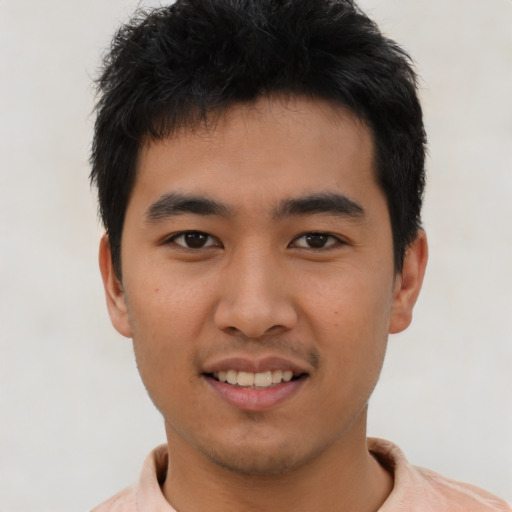 Joyful white young-adult male with short  black hair and brown eyes