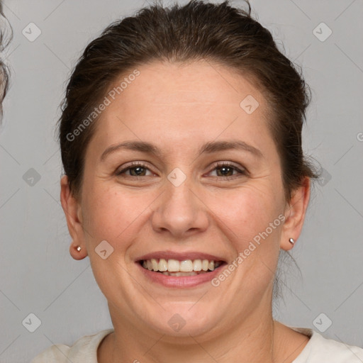 Joyful white adult female with short  brown hair and grey eyes