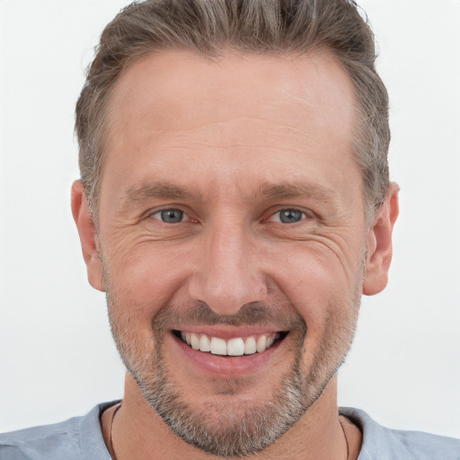 Joyful white adult male with short  brown hair and grey eyes