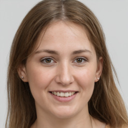 Joyful white young-adult female with long  brown hair and grey eyes