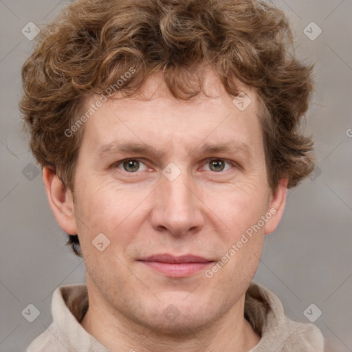 Joyful white adult male with short  brown hair and grey eyes