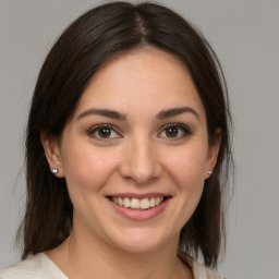 Joyful white young-adult female with medium  brown hair and brown eyes