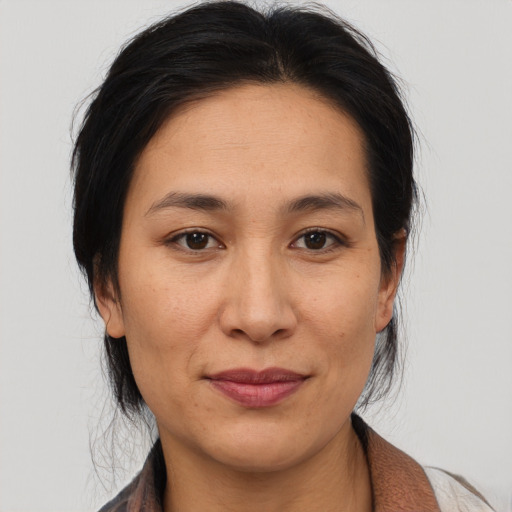 Joyful asian adult female with medium  brown hair and brown eyes