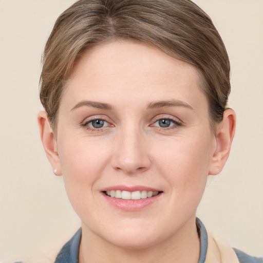 Joyful white young-adult female with short  brown hair and grey eyes