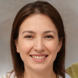 Joyful white adult female with medium  brown hair and brown eyes