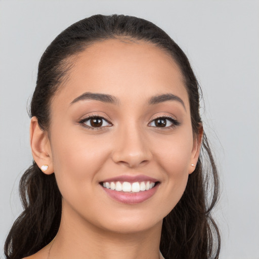 Joyful white young-adult female with long  brown hair and brown eyes