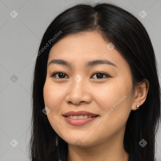 Joyful asian young-adult female with long  brown hair and brown eyes