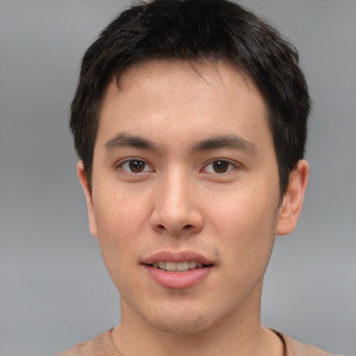 Joyful asian young-adult male with short  brown hair and brown eyes