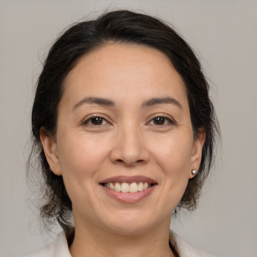 Joyful white adult female with medium  brown hair and brown eyes