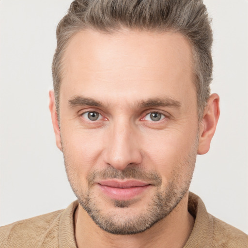 Joyful white adult male with short  brown hair and brown eyes