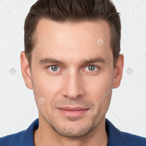 Joyful white young-adult male with short  brown hair and grey eyes