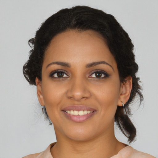 Joyful black young-adult female with medium  black hair and brown eyes