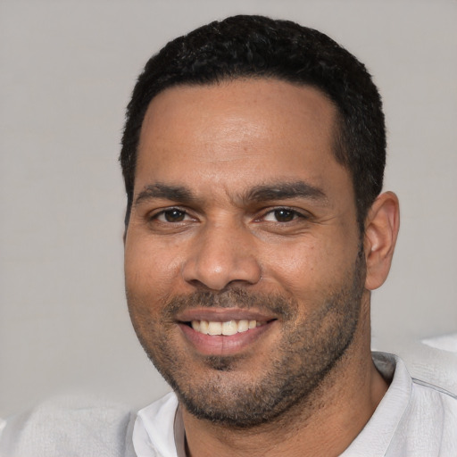 Joyful white young-adult male with short  black hair and brown eyes