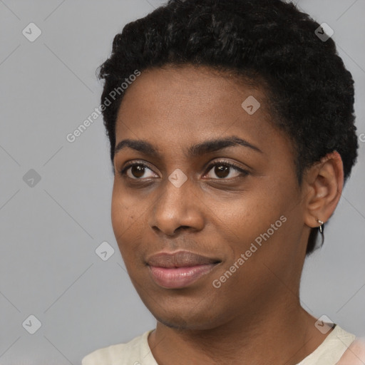 Joyful black young-adult female with short  black hair and brown eyes