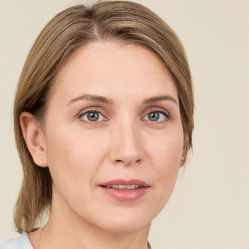 Joyful white young-adult female with medium  brown hair and green eyes